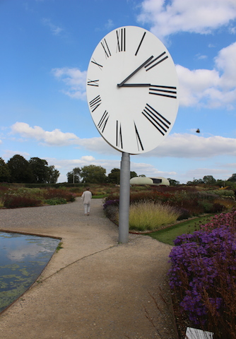giant clock sculpture in meadow garden hauser and wirth Bruton