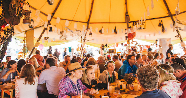 Festival Goers eating in a big tent