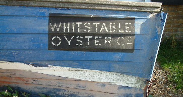 Whitstable Oyster Co. blue boat on the beach