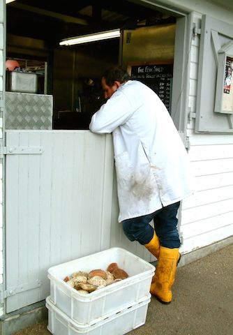 fisherman in yellow wellies at the Fish Shed in Topsham