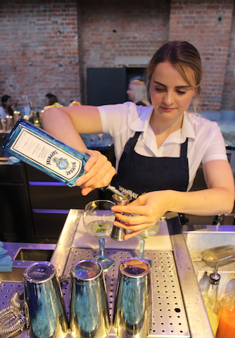 Bartender pouring Bombay Sapphire gin and tonic