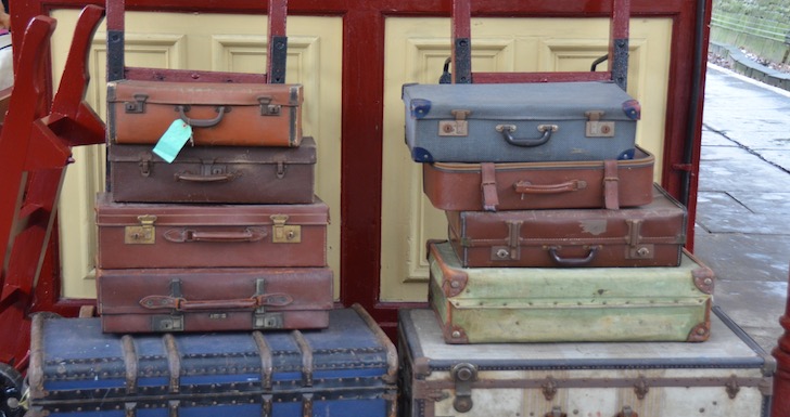 Stack of vintage suitcases on railway platform