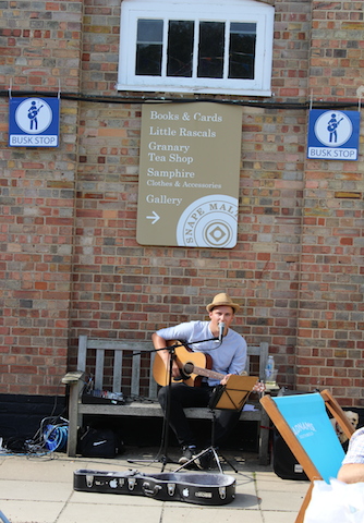 Busker singing playing guitar
