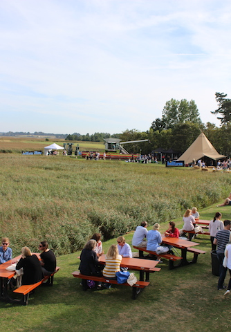 Festival visitors eating at picnic tables snape maltings