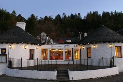 White washed exterior of the Pier House Hotel photograped at night