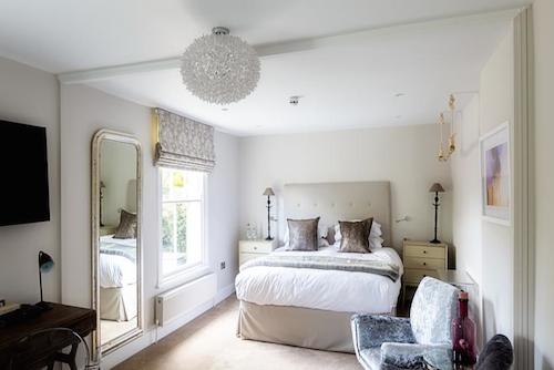Luxury bedroom decorated in neutral tones at The Goudhurst Inn