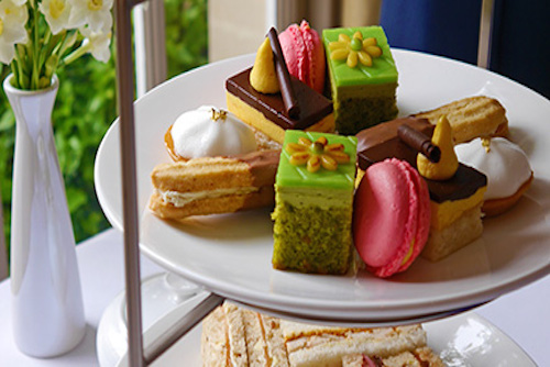 Plate of fancy cakes and fingers sandwiches for Afternoon Tea