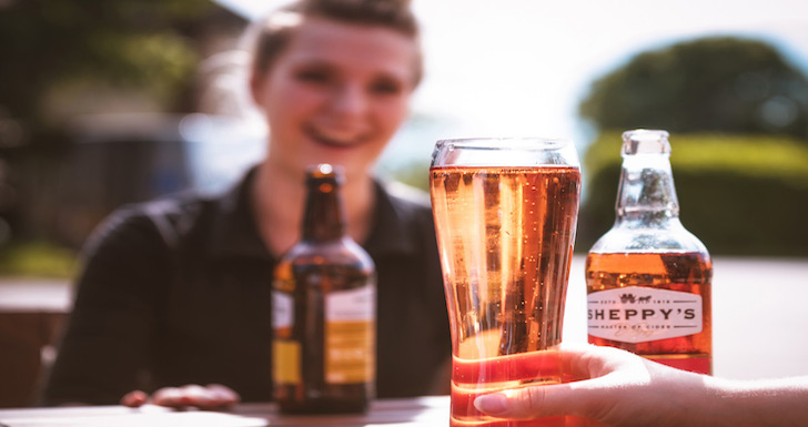 Visitors drinking cider on Sheppys tour somerset