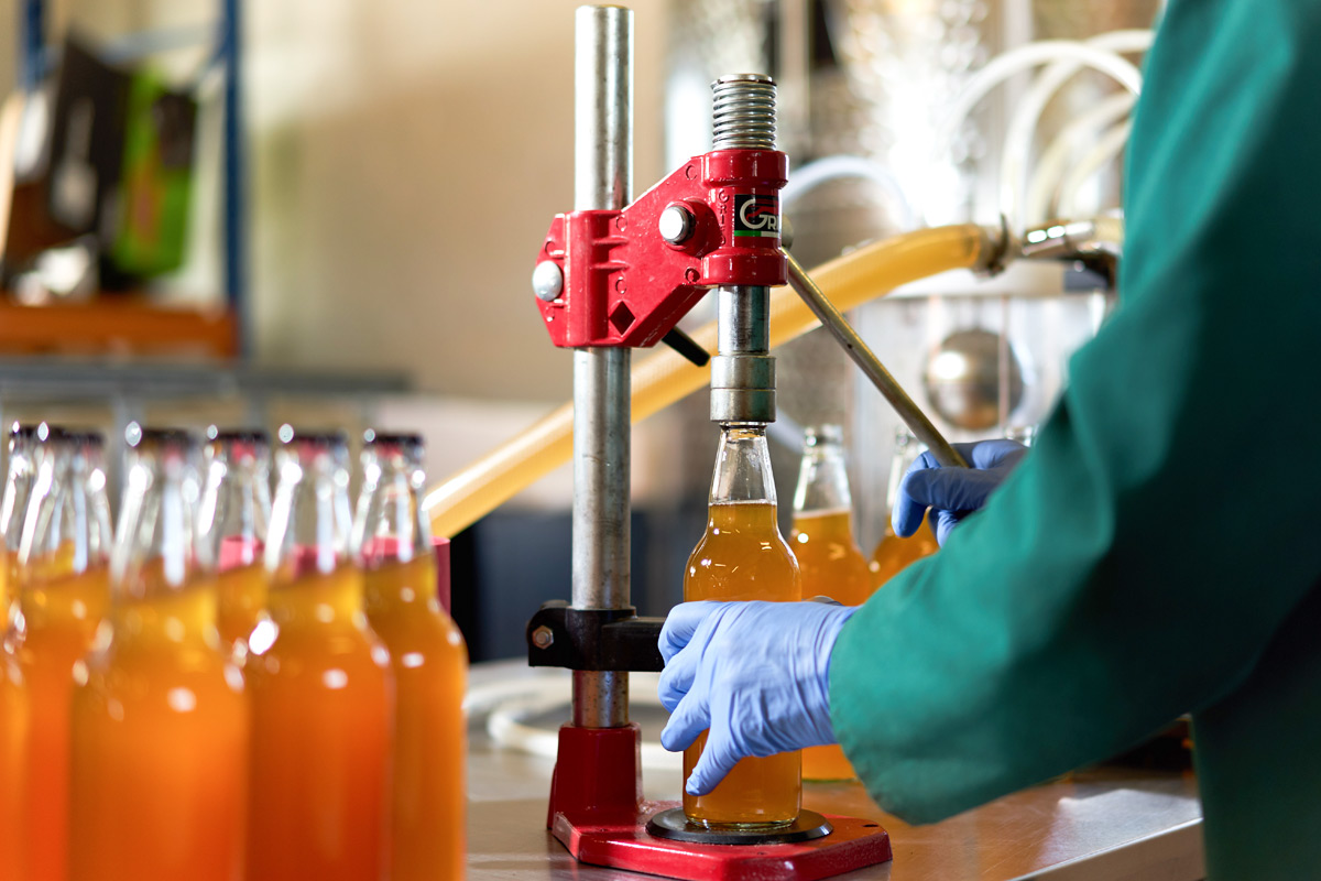 bottles being filled with craft cider