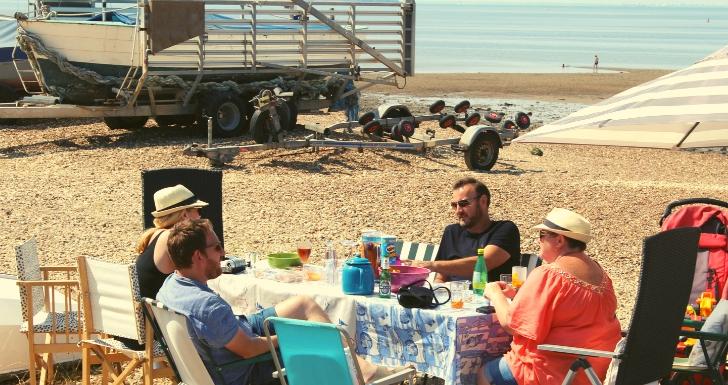 People having a picnic Whitstable beach Kent