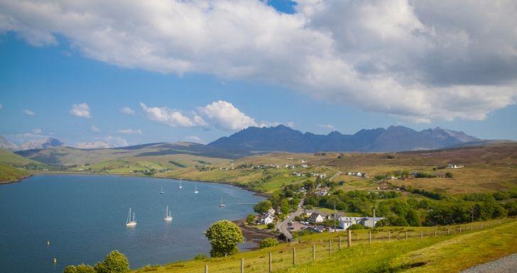 View of the Talisker distillery and Cuillins Skye Scotland